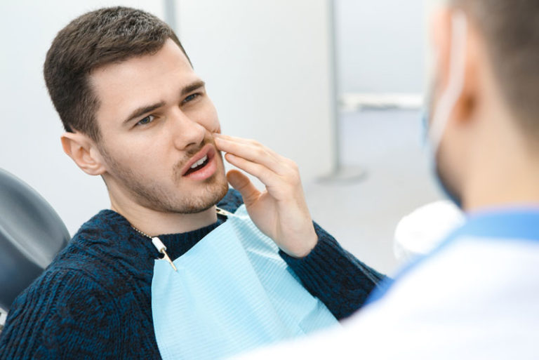 Dental Patient Suffering From Mouth Pain On A Dental Chair, In Monroe, CT