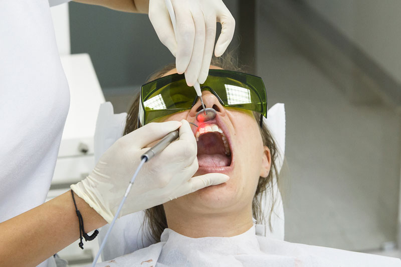 a dental implant patient receiving treatment for peri-implantitis.